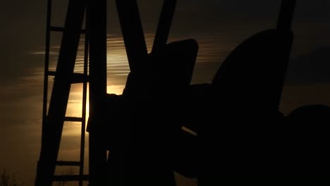 Closeup-Of-A-Silhouetted-Oil-Pump-Turning-In-The-New-Mexico-Desert