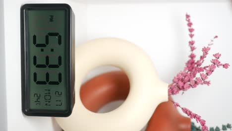 digital clock and decorative vases