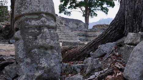 carved head stone in mayan cemetery at ancient copan ruins in honduras