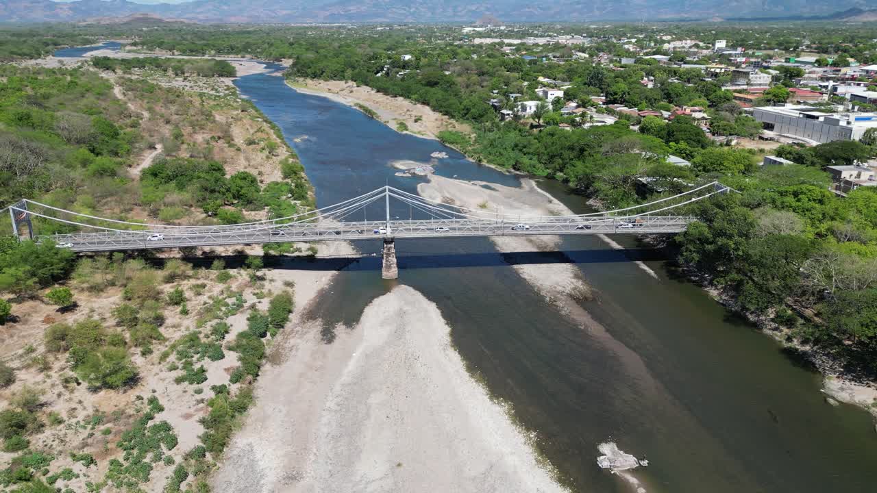 Aerial panorama of Choluteca, Honduras featuring cable bridge and suburban development
