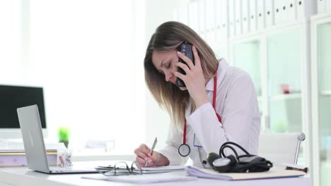 Female Doctor on Phone Taking Notes