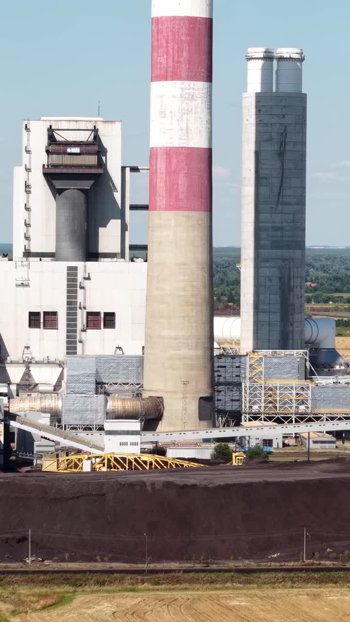 Industrial Smokestacks Against a Cloudy Sky