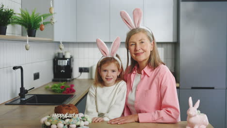 grandmother and granddaughter celebrating easter in the kitchen