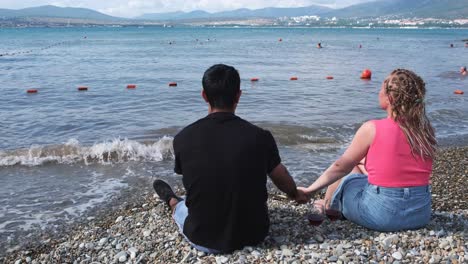 couple enjoying the beach and wine