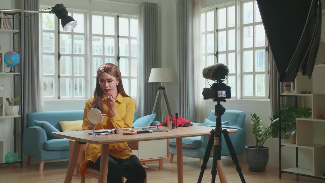 Influencer Young Transgender Woman Blogger Makeup. Transgender Woman Looks And Smiles To Camera In Home Studio With Professional Lighting Equipment