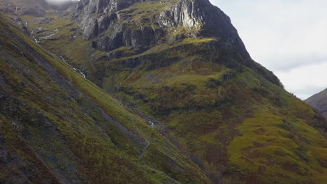 steep rocky mountain valley has small whitewater creek tumbling down