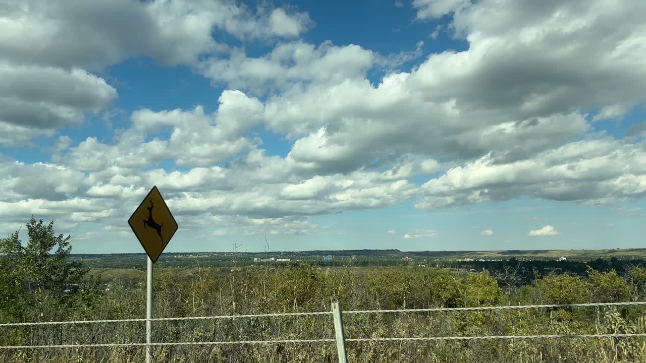 Beautiful Summer Landscape with Cumulus Clouds and City in the Distance