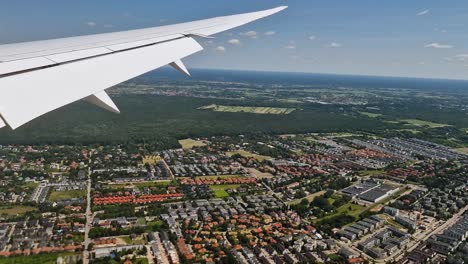 flying above suburbs of warsaw before landing on chopin international airport, poland. plane passenger pov