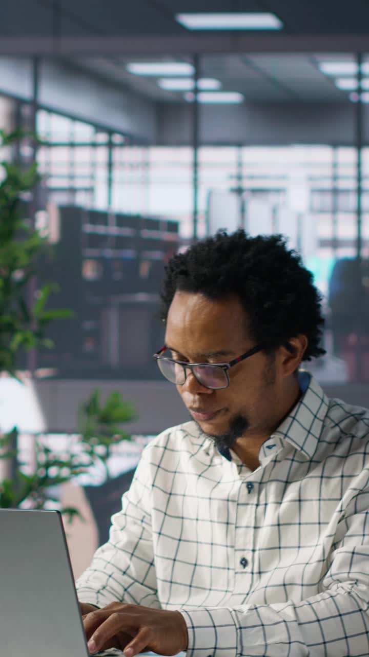 Focused African American Man Working on Laptop in Modern Office