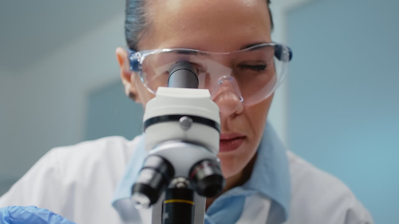 Scientist using a microscope in a laboratory