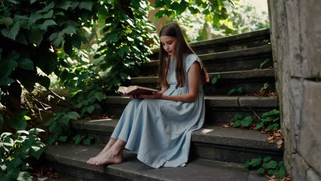 girl reading a book in a garden