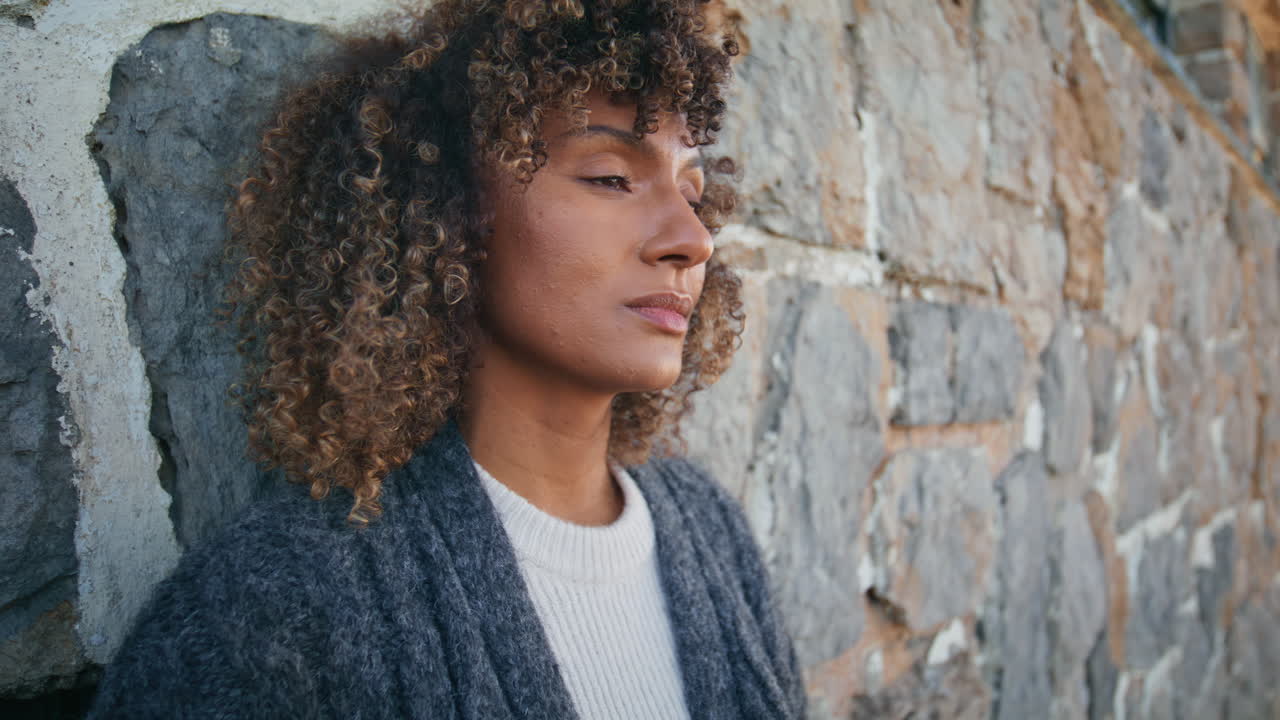 Upset woman thinking wall at autumn nature closeup. Girl enjoying light wind