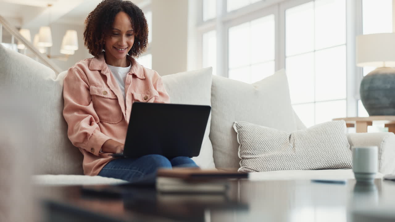Woman Working on Laptop at Home