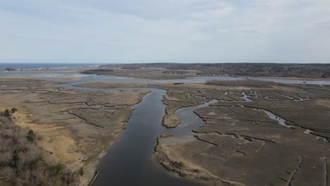 slow aerial descent over a large waterway in the driftway region of scituate, ma