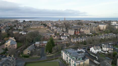 aerial pull back with saint andrews town in background