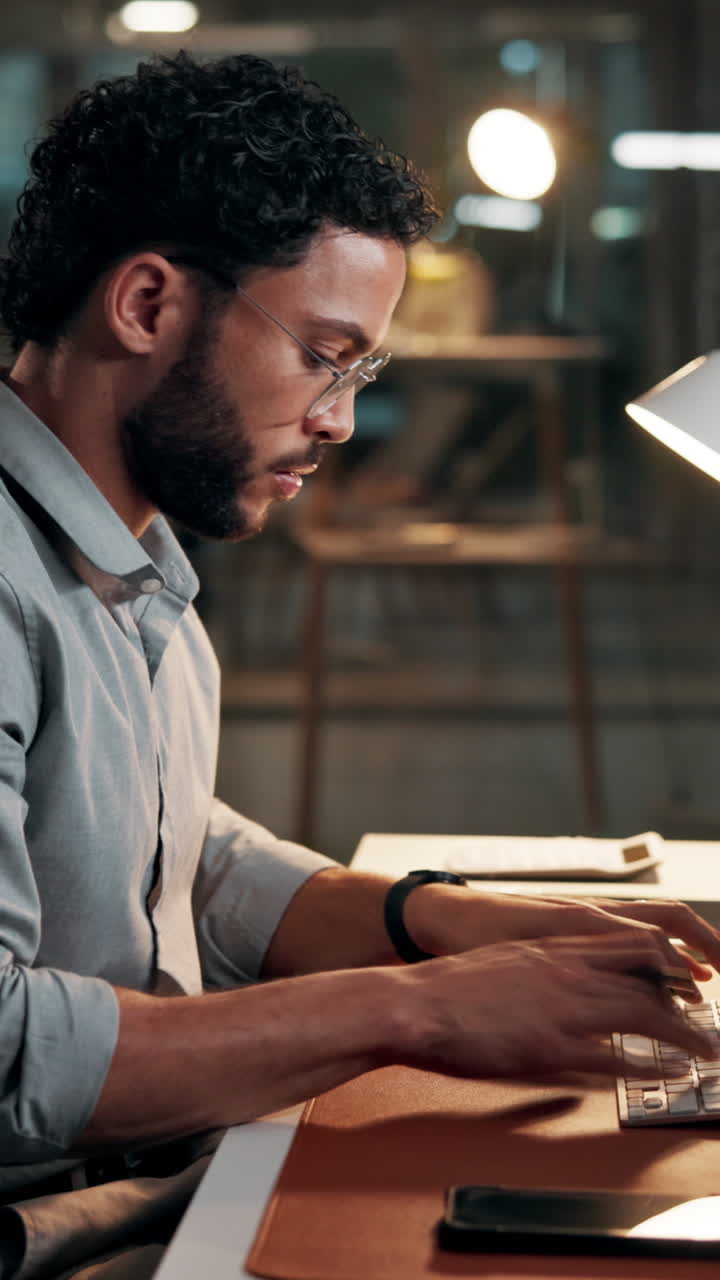 Focused Man Working on Computer at Desk in Office
