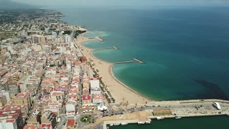 aerial view of a coastal town with beach and harbor