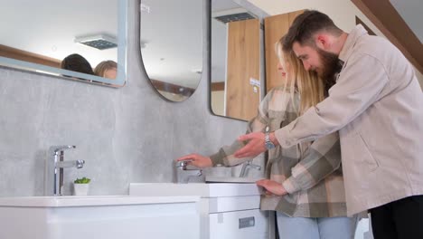 couple choosing bathroom fixtures in showroom