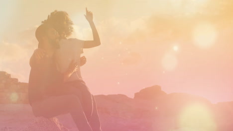 couple sitting on rocks with colorful light effects animation