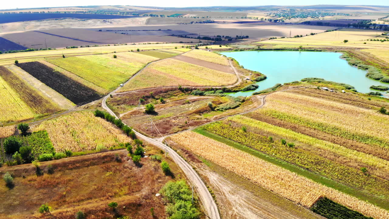 Aerial drone view of a village and lake from north part of Moldova. Sunny day