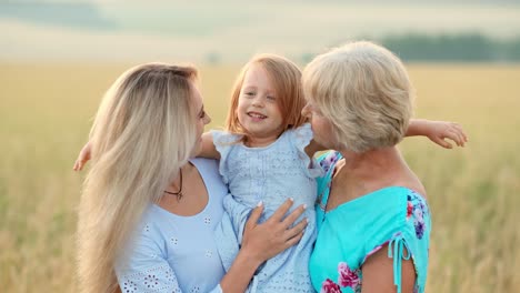 grandmother, mother and granddaughter in a field
