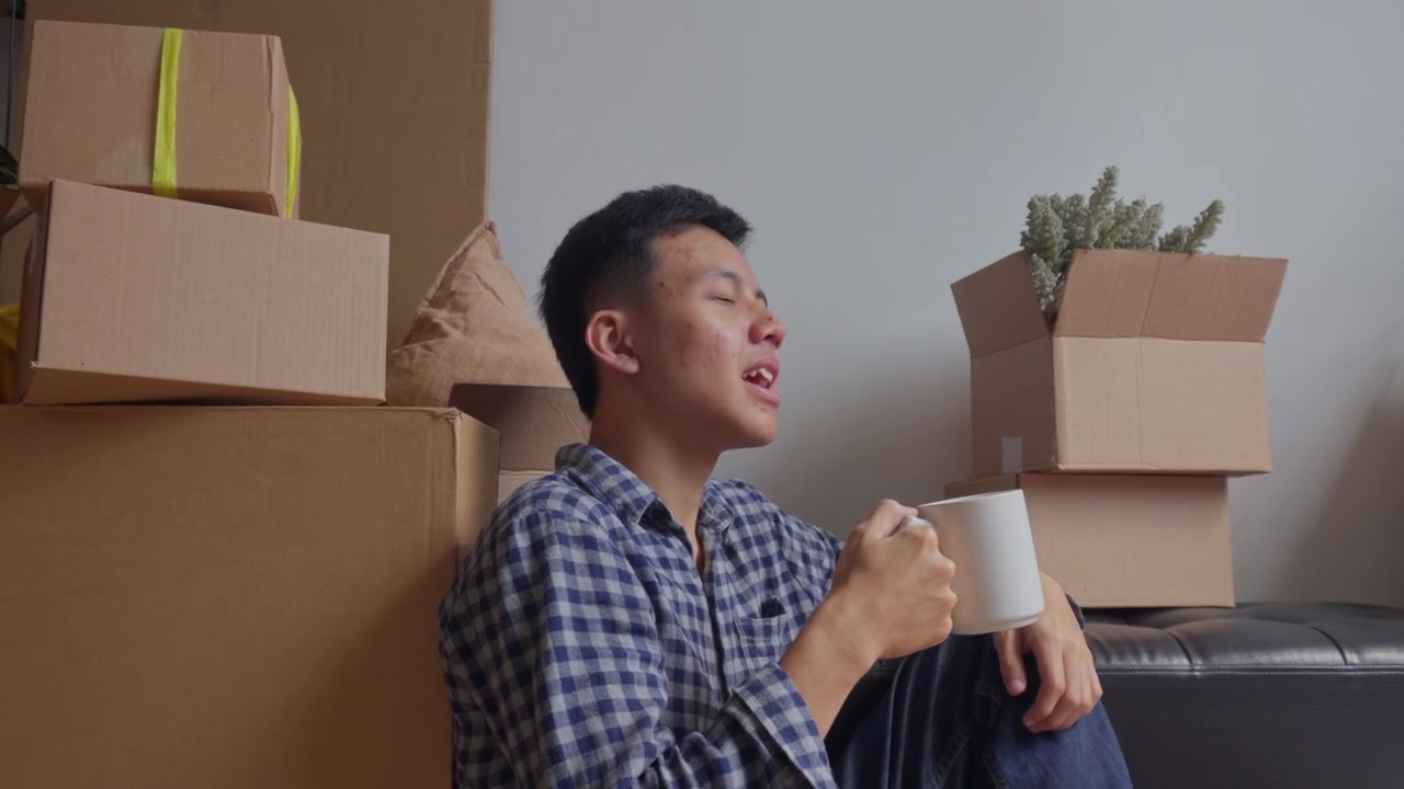 Man takes peaceful coffee break while sitting on the floor