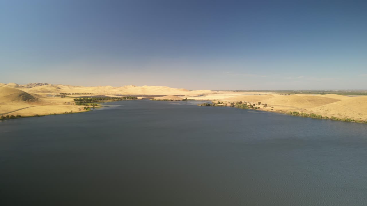 Aerial View of a Calm Lake Surrounded by Dry Hills