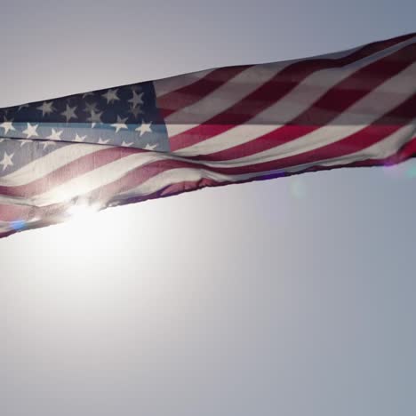 american flag flutters in the wind in the sun 2