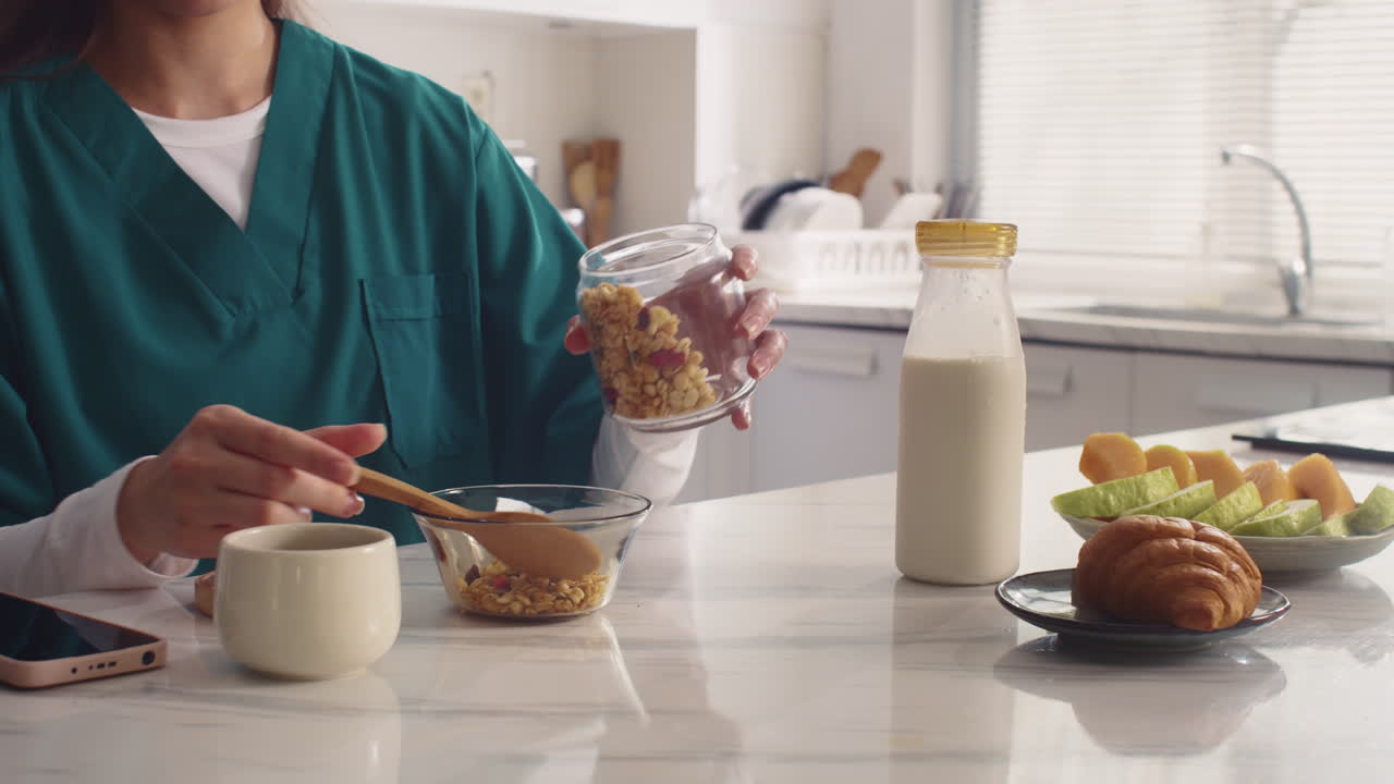 Unrecognizable Healthcare Worker Eating Muesli during Breakfast