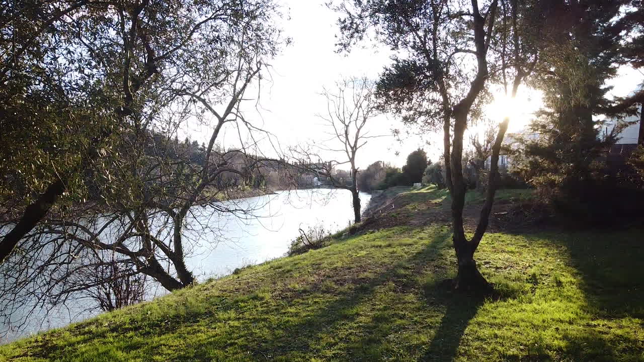Riverside flying in Sunset drone above the Arno river. Girone small town near Fiesole Florence, in the Tuscany region of Italy. December 2019