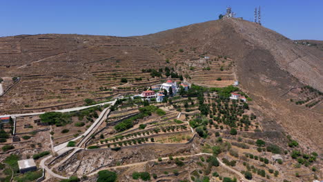 aerial: slow panoramic drone shot of monastery of saint barbara in ermoupoli city of syros island, greece