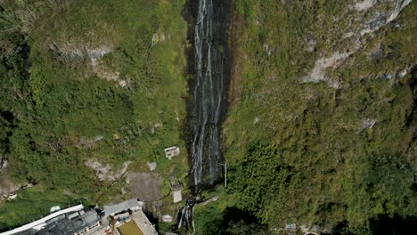 fly away at virgin waterfalls flowing down from sheer mountains in baños, ecuador