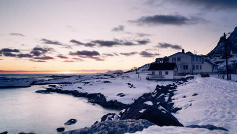 time lapse of a calm sea during sunset behind a house on a lofoten coast in winter