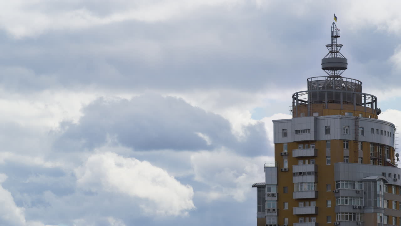 Gray clouds rolling over city before rain. Residential building tower drone shot