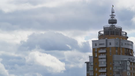 Gray-clouds-rolling-over-city-before-rain.-Residential-building-tower-drone-shot