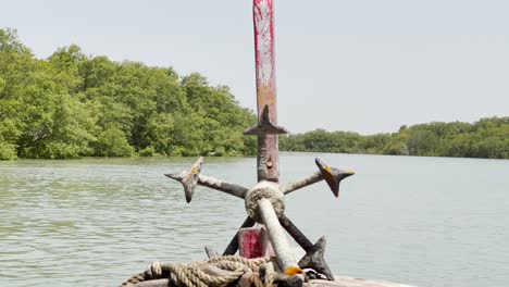 Boat-with-Anchor-Glides-Through-Mangroves,-Sindh,-Pakistan