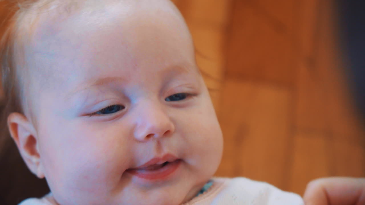 파란 눈과 두꺼운 뺨을 가진 행복한 하얀 아기