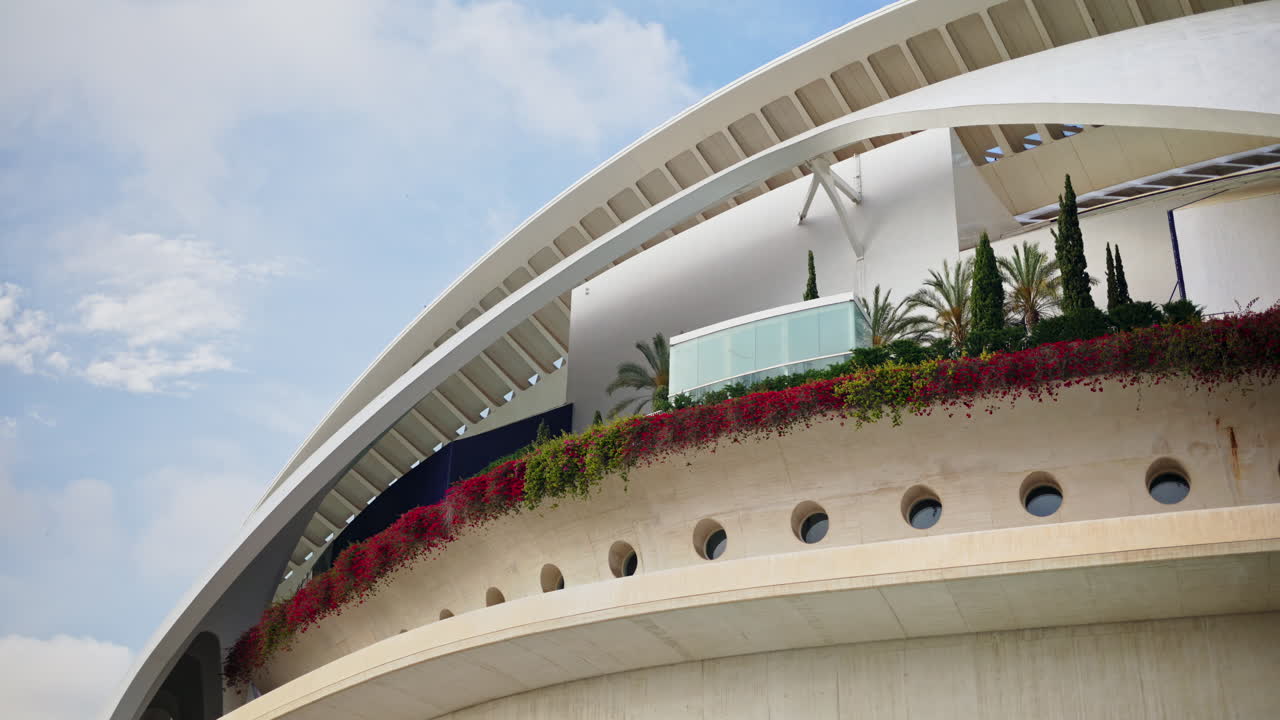 Valencia, Spain - May 28, 2025: View of the Palau de les Arts white concrete shells and fins against a cloudy sky