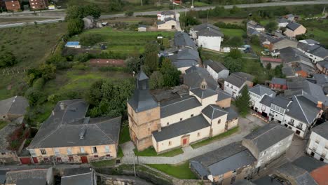 drone orbit of san esteban church in a rúa, galicia, spain, showcasing its layout and surroundings
