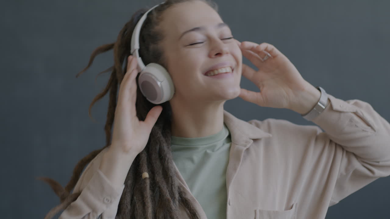 Woman with Headphones Dancing to Music