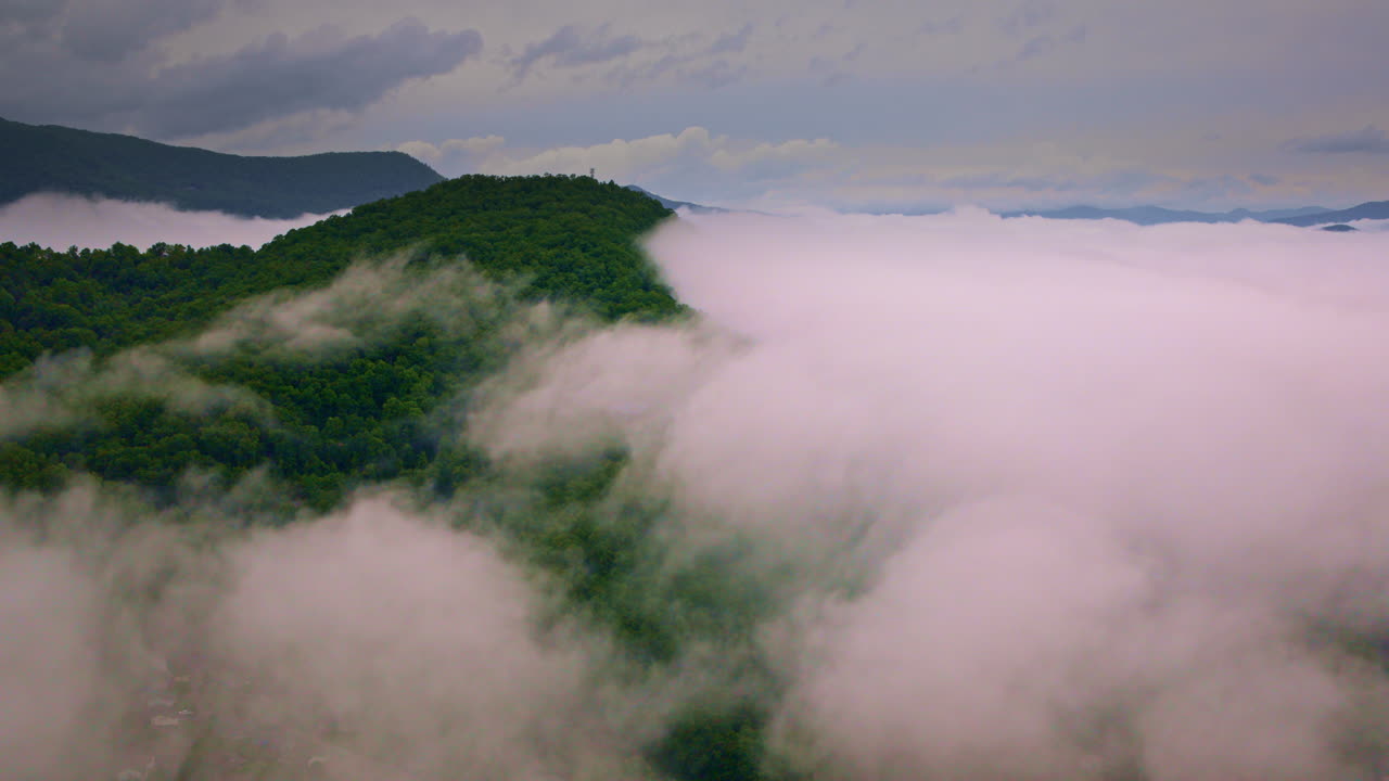 Smoky Mountain peaks pierced by drifting fog in drone view