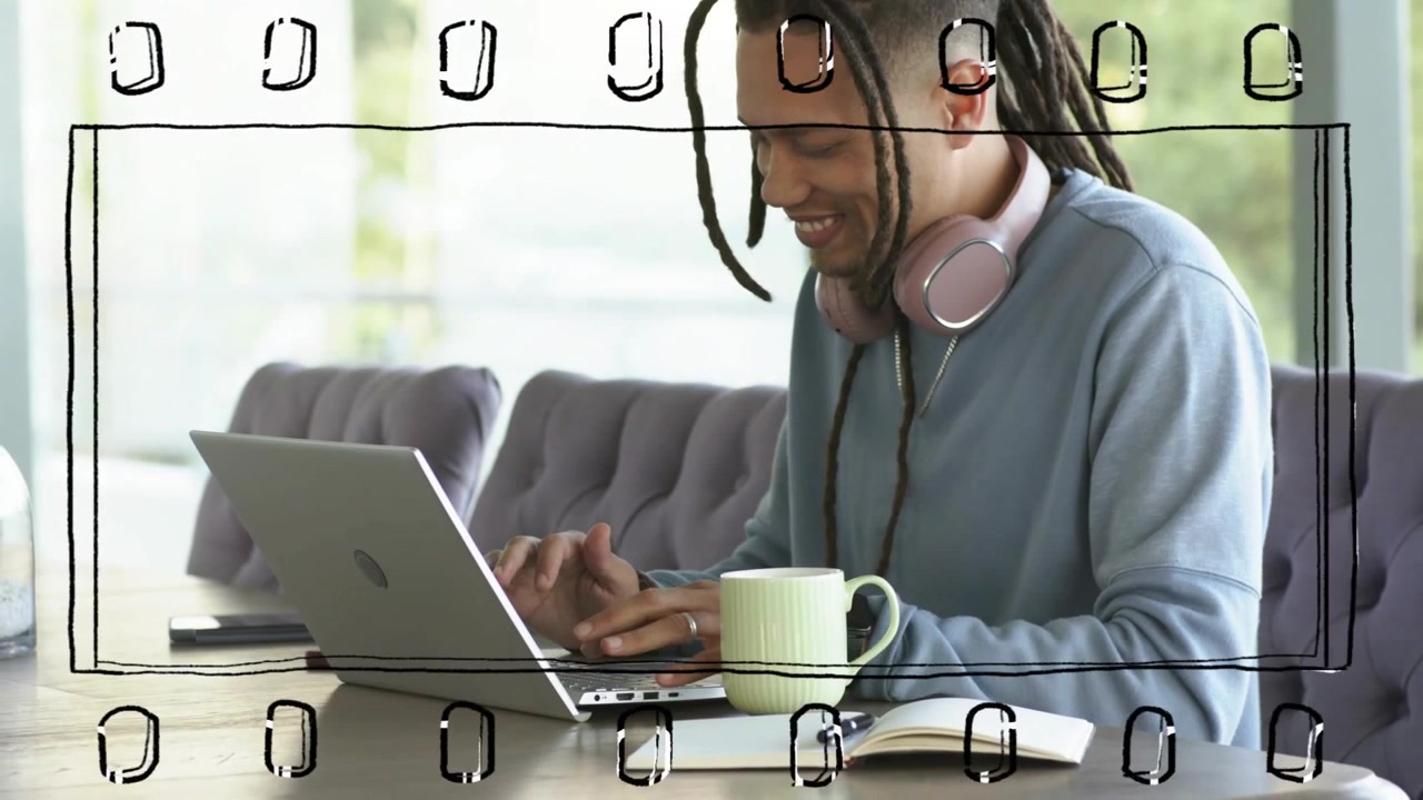 Man sitting at wooden table starting typing on laptop for remote work, filmstrip framing scene