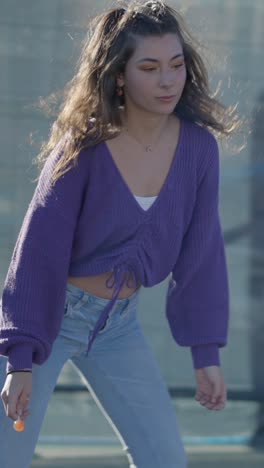 young woman holding a lollipop outdoors