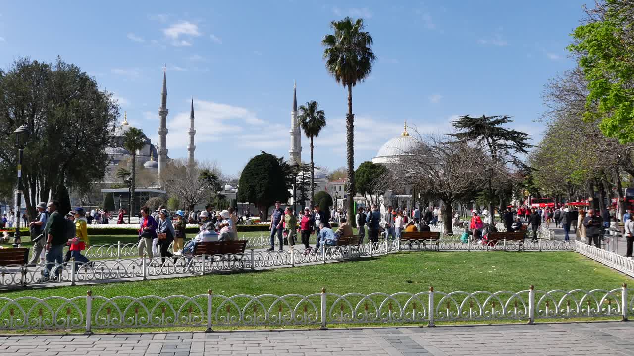 A large group of people walk through a park in Istanbul, Turkey. The ...