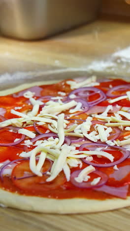 the process of making pizza. chef preparing pizza in restaurant kitchen. vertical video