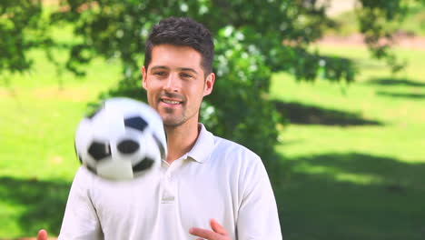 young man playing with a ball outdoors