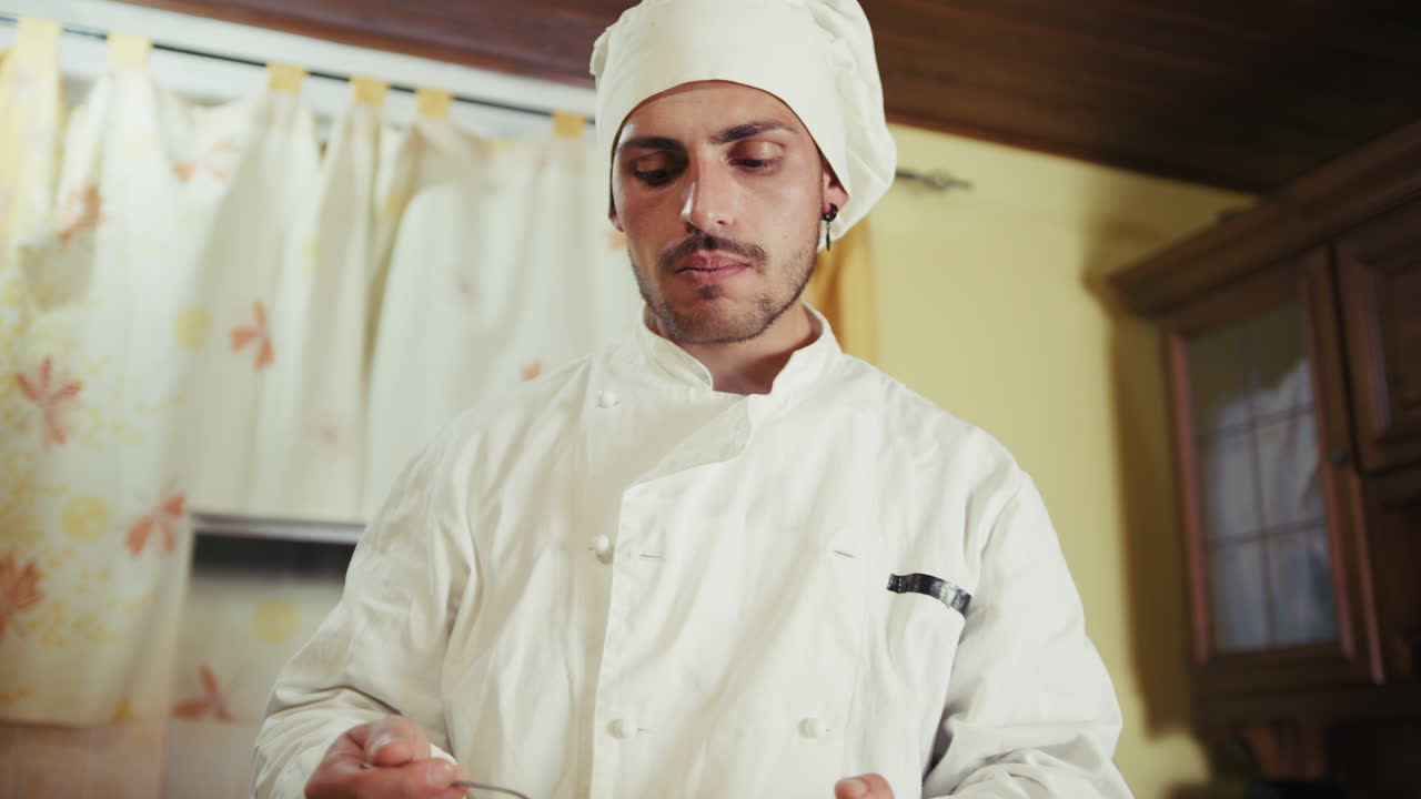 Private Home Chef Tasting His Tomato Sauces With a Spoon