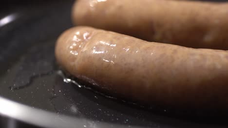 closeup shot of sauage cooking in pan