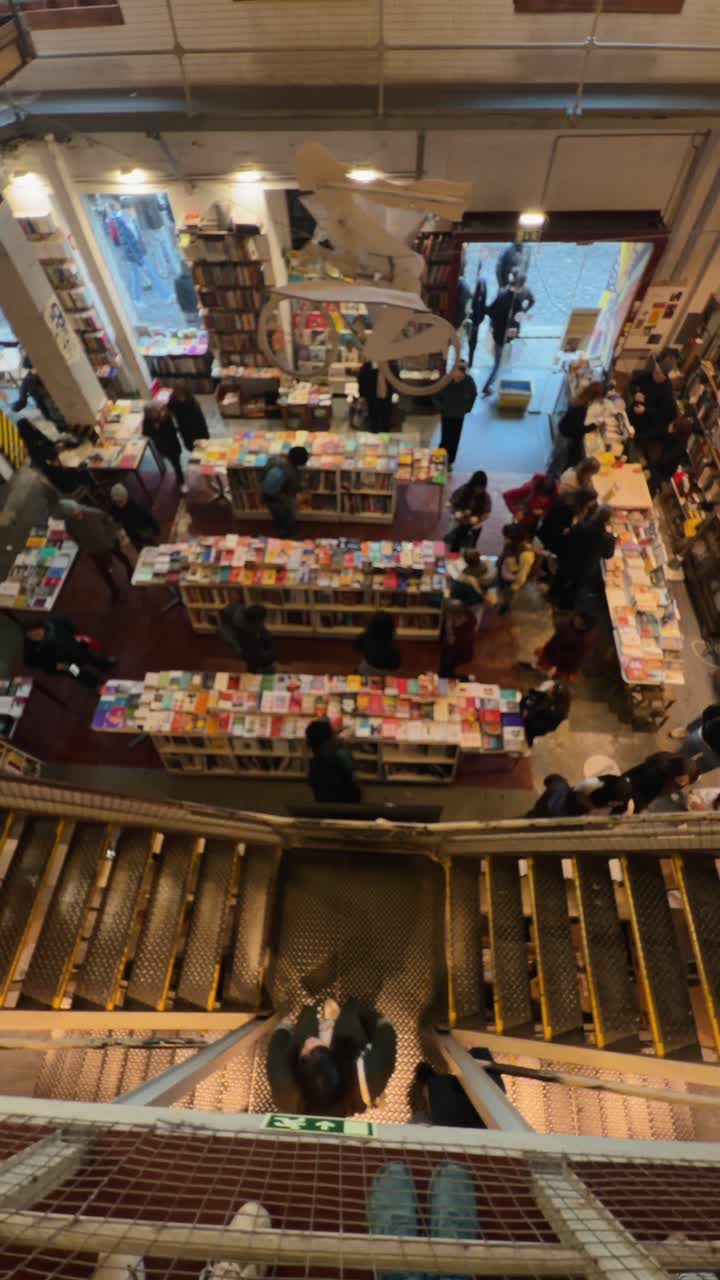 Overhead View of People Browsing Books in a Busy Bookstore | Premium ...