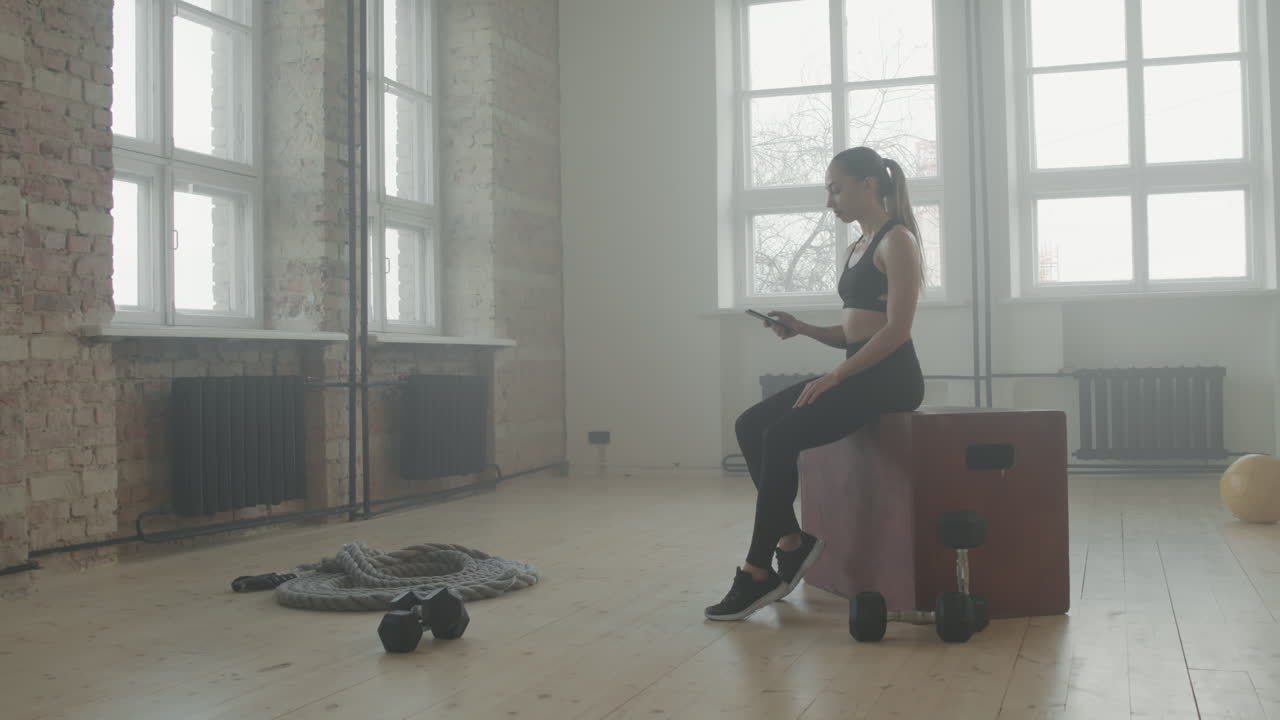 Sports Woman Using Smartphone After Workout